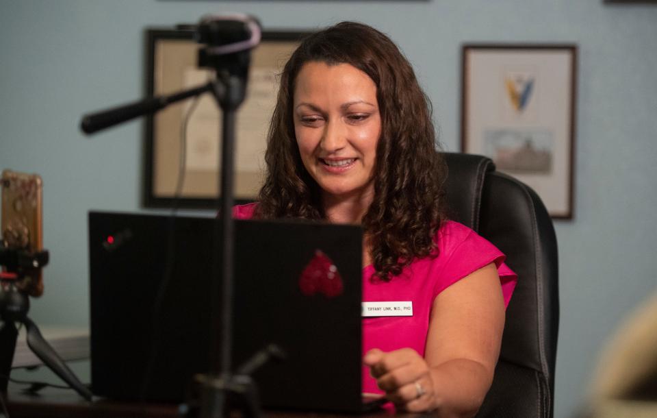 Dr. Tiffany Link listens to a patient during a telehealth session in her spare bedroom in her home in Fort Collins, Colo., on May 20.