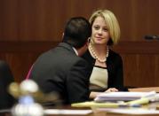 New Jersey Governor Chris Christie's former Deputy Chief of Staff Bridget Anne Kelly waits in court for a hearing in Trenton, New Jersey March 11, 2014. A New Jersey Superior Court judge was scheduled to hear arguments Tuesday about whether Kelly and Christie's former campaign manager, Bill Stepien, have to turn over documents to a New Jersey state legislative committee investigating the September 2013 lane closures on the George Washington bridge. (REUTERS/Mel Evans/Pool)