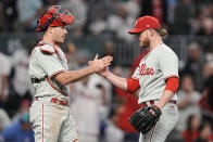 Philadelphia Phillies closer Craig Kimbrel, right, speaks with Philadelphia Phillies catcher J.T. Realmuto after Game 1 of a baseball NL Division Series, Saturday, Oct. 7, 2023, in Atlanta. The Philadelphia Phillies won 3-0. (AP Photo/Brynn Anderson)