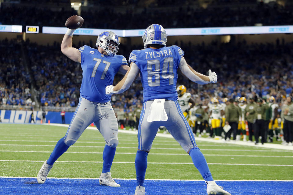 Detroit Lions center Frank Ragnow (77) spikes the ball after tight end Shane Zylstra's 1-yard reception for a touchdown during the first half of an NFL football game against the Green Bay Packers, Sunday, Nov. 6, 2022, in Detroit. (AP Photo/Duane Burleson)