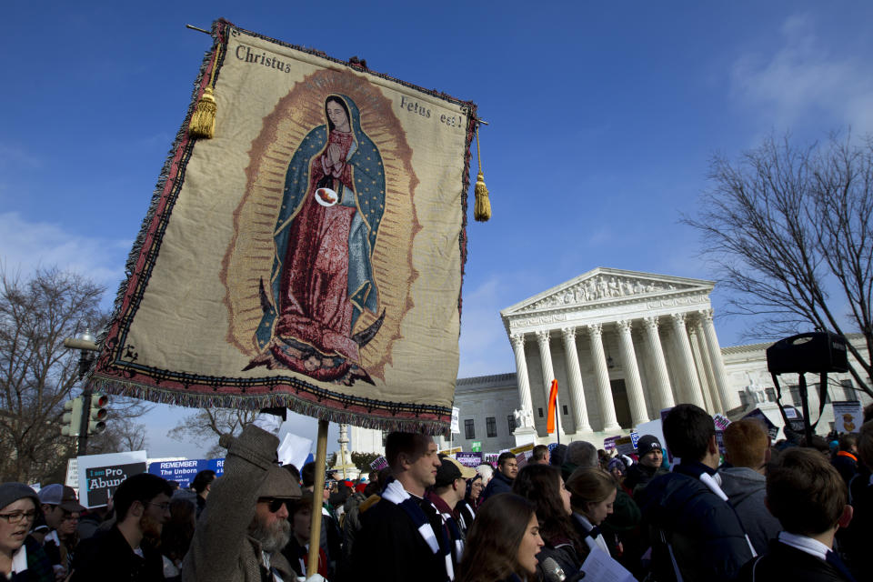 Anti-abortion activist holds an images of Our Lady of Guadalupe as they march outside the U.S. Supreme Court during the March for Life in Washington, Friday, Jan. 18, 2019. (AP Photo/Jose Luis Magana)