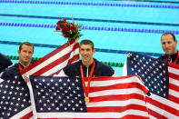 <b>Medal No. 16</b><br>Michael Phelps stands between teammates Brendan Hansen and Jason Lezak after winning the gold medal in the Men's 4x100 Medley Relay in Beijing. The United States team set a new world record with a time of 3:29:34.