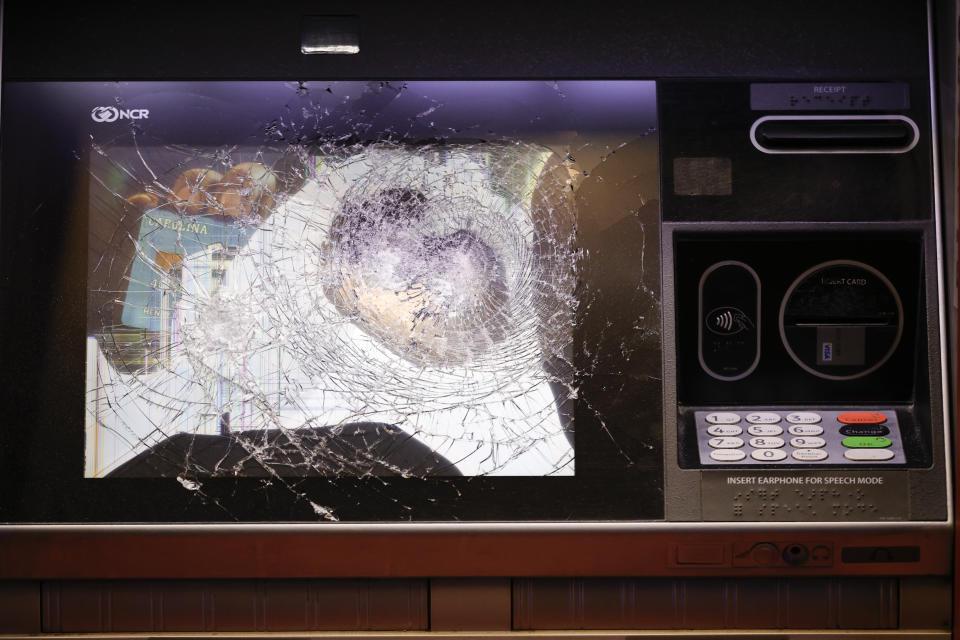 A smashed ATM is seen at a Wells Fargo branch following a protest, late Saturday, Jan. 21, 2023, in Atlanta, in the wake of the death of an environmental activist killed after authorities said the 26-year-old shot a state trooper. (AP Photo/Alex Slitz)