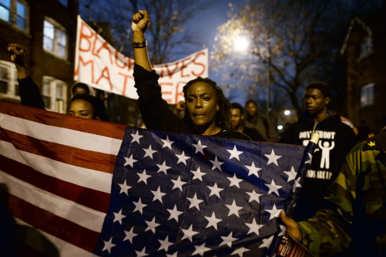 Demonstrators shout slogans during a march in St. Louis, Missouri, on November 23, 2014 to protest against the death of Michael Brown