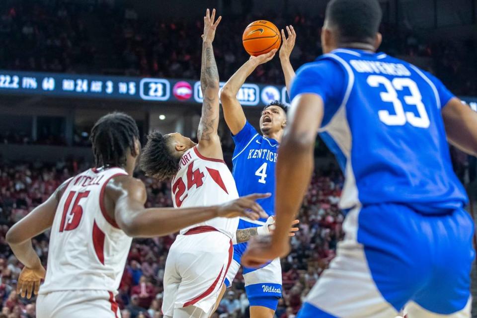 Kentucky forward Tre Mitchell (4) shoots the ball as Arkansas guard Jeremiah Davenport (24) defends during Saturday’s game at Bud Walton Arena in Fayetteville, Ark.