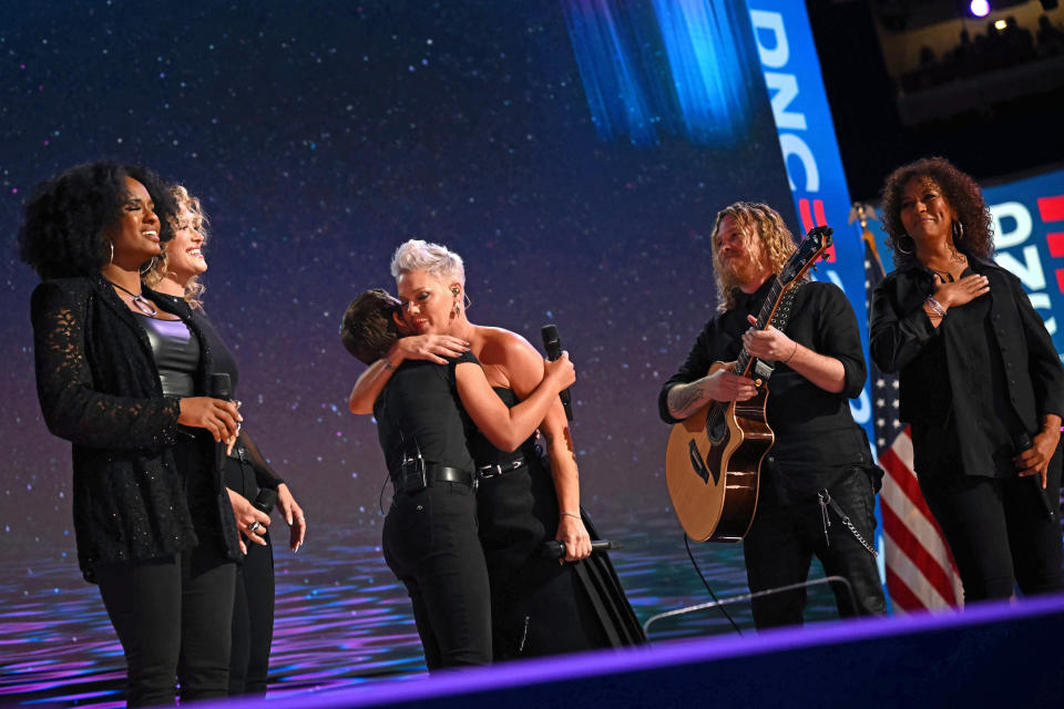 American singer-songwriter Pink (center) embraces her daughter Willow during their performance on the fourth and final day of the Democratic National Convention (DNC) at the United Center in Chicago, Illinois, on August 22, 2024. Vice President Kamala Harris will formally accept the party's nomination for president today during the DNC, held in Chicago from August 19 to 22. (Photo by ANDREW CABALLERO-REYNOLDS / AFP) (Photo by ANDREW CABALLERO-REYNOLDS/AFP via Getty Images)