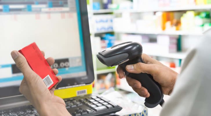 A close-up shot of a cashier using a barcode scanner.