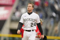 Colorado Rockies' Ryan McMahon heads to the dugout after being forced out at second base on the front end of a double play hit into by Garrett Hampson to end the ninth inning of a baseball game against the Cincinnati Reds Sunday, May 16, 2021, in Denver. (AP Photo/David Zalubowski)