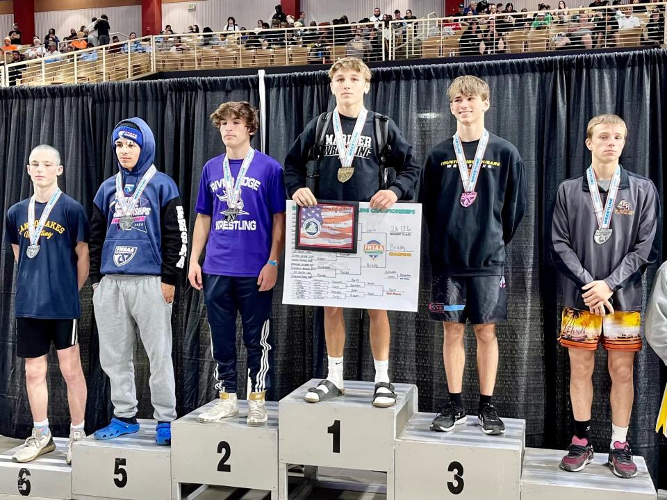 Mariner's Maximus Brady poses after coming in first in the Class 2A 126-pound class at the FHSAA state tournament on March 4, 2023.