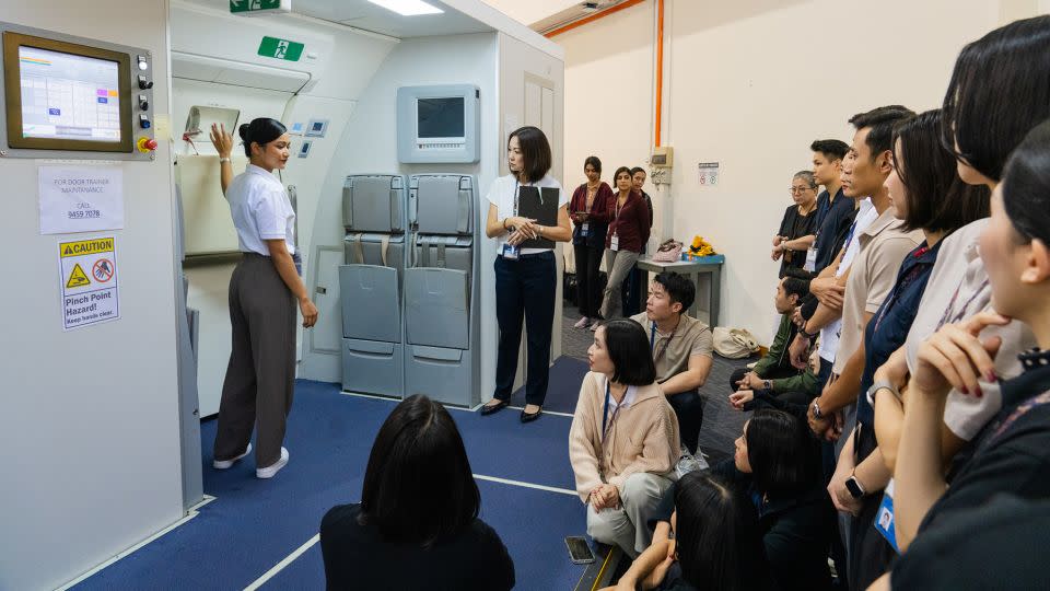 Cabin crew go through rigorous training. Pictured here: Singapore Airlines trainees at the company's training centre in Singapore. - Nicky Loh/Bloomberg/Getty Images