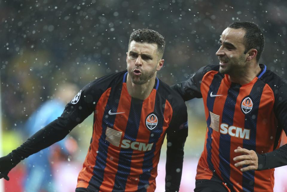 Shakhtar Junior Moraes, left, celebrates with his teammate Ismaily Ismaily after scoring his side's opening goal during the Group F Champions League soccer match between Shakhtar Donetsk and Lyon at the Olympiyskiy stadium, in Kiev, Ukraine, Wednesday, Dec.12, 2018. (AP Photo/Efrem Lukatsky)