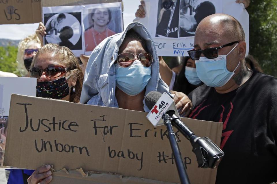 Felina Ramirez, center, and Farid Majail, right, the mother and step-father of Erik Salgado, rally in front of Highland Hospital in Oakland.