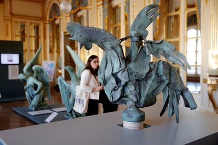 The iconic copper rooster, which was perched at the top of the spire of Notre-Dame Cathedral for more than a century is displayed at the exhibition "Revoir Notre-Dame de Paris\