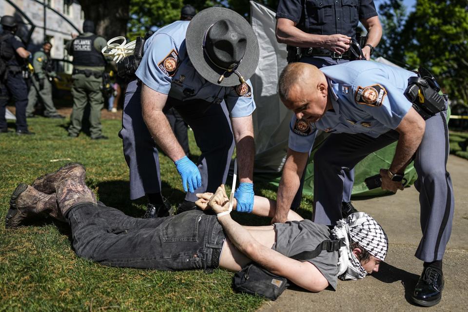 Georgia State Patrol officers detain a protester on the campus of Emory University during an pro-Palestinian demonstration Thursday, April 25, 2024, in Atlanta. (AP Photo/Mike Stewart)