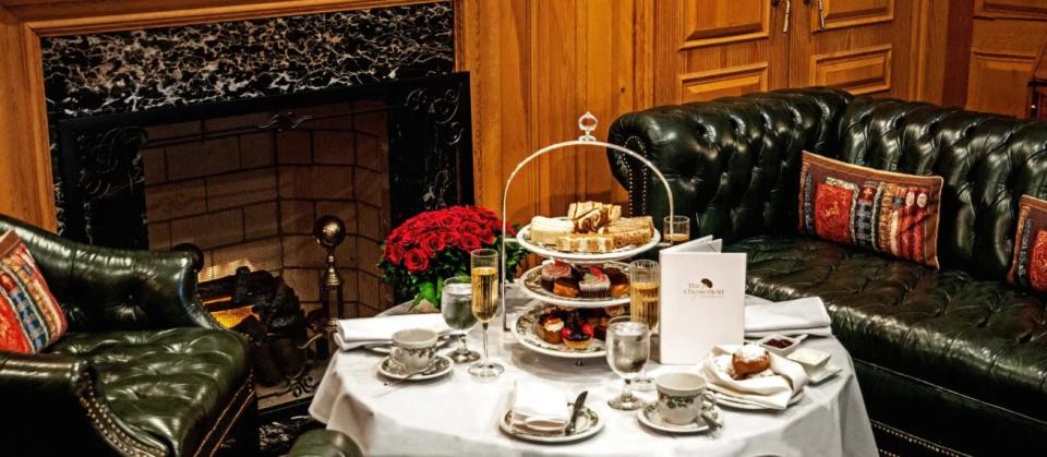 Afternoon tea service laid out in The Chesterfield's wood-paneled library; champagne is an add-on and not included in the price of afternoon tea.