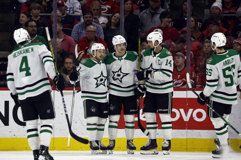 Dallas Stars' Wyatt Johnston (53) center, celebrates after his goal with teammates Miro Heiskanen (4), Logan Stankoven (11), Jamie Benn (14) and Thomas Harley (55) during the second period of an NHL hockey game against the Carolina Hurricanes in Raleigh, N.C., Saturday, Feb. 24, 2024. (AP Photo/Karl B DeBlaker)