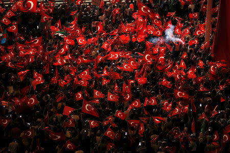 Supporters of Turkish President Tayyip Erdogan wave Turkish national flags during a pro-government demonstration on Taksim square in Istanbul, Turkey, July 18, 2016. REUTERS/Alkis Konstantinidis