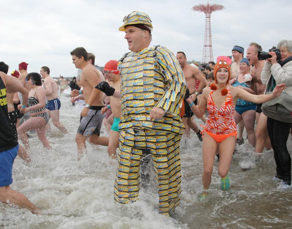 NEW YORK, NY - JANUARY 1: A man wearing a costume made of Metrocards takes part in the Coney Island Polar Bear Club's New Year's Day swim on January 1, 2013 in the Coney Island neighborhood of the Brooklyn borough of New York City. The annual event attracts hundreds who brave the icy Atlantic waters and temperatures in the upper 30's as a way to celebrate the first day of the new year. (Photo by Monika Graff/Getty Images)