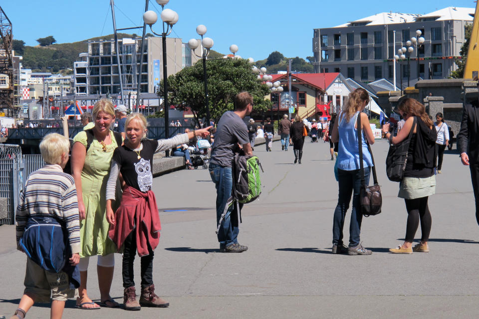 In this Oct. 30, 2012 photo, people take advantage of fine weather to stroll along the Wellington waterfront, New Zealand. Whether you're a fan making a pilgrimage to the city where the “The Lord of the Rings” films were made, or you have no interest whatsoever in dwarfs and goblins, there's plenty to do in Wellington. For free. (AP Photo/Nick Perry)