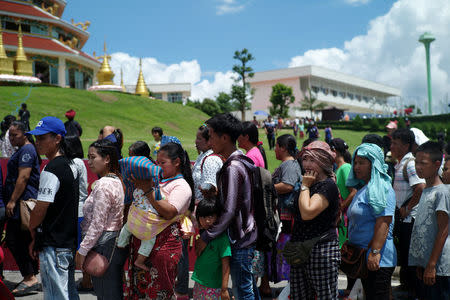 Ethnic minorities line up at a temple fair, in the northern province of Chiang Rai, Thailand July 13, 2018. Picture taken July 13, 2018. REUTERS/Panu Wongcha-um