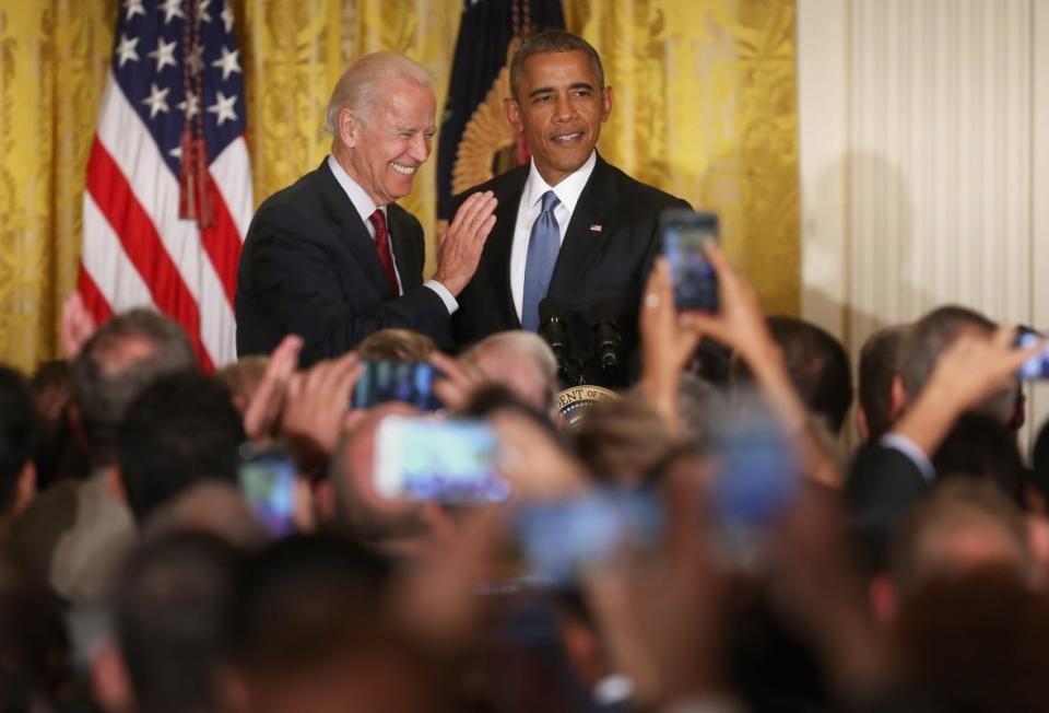 U.S. President Barack Obama (R) and Vice President Joe Biden react after a heckler is removed from a reception for LGBT Pride Month in the East Room of the White House June 24, 2015 in Washington, D.C. (Photo by Chip Somodevilla/Getty Images)