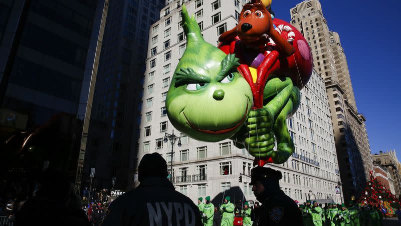 In this Nov. 22, 2018, file photo, the Grinch balloon floats over Central Park West during the 92nd annual Macy’s Thanksgiving Day Parade in New York.