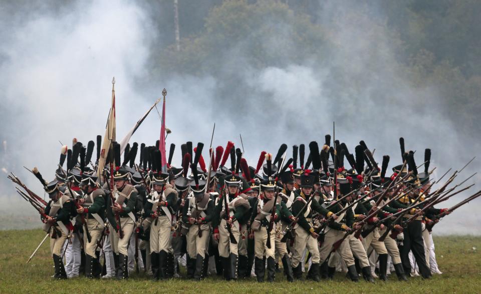 Members of historic clubs wearing 1812-era uniforms take part in a staged battle re-enactment to mark the 200th anniversary of the battle of Borodino, in Borodino, about 110 km (70 miles) west of Moscow, Sunday, Sept. 2, 2012. The Battle of Borodino in 1812 was the largest and bloodiest single-day action of the French invasion of Russia. (AP Photo/Mikhail Metzel)