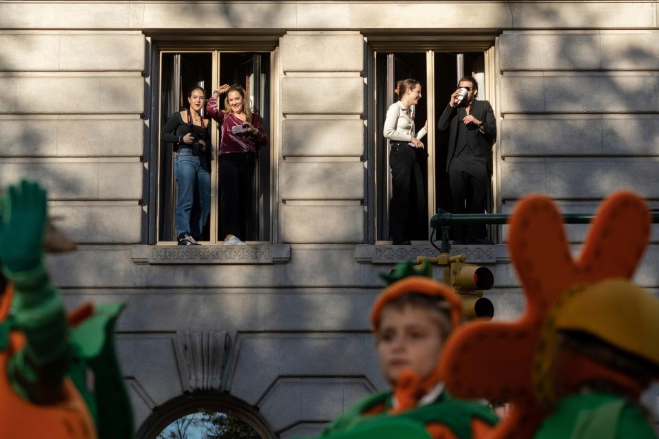 Spectators watch from a balcony along Central Park West during the Macy's Thanksgiving Day parade