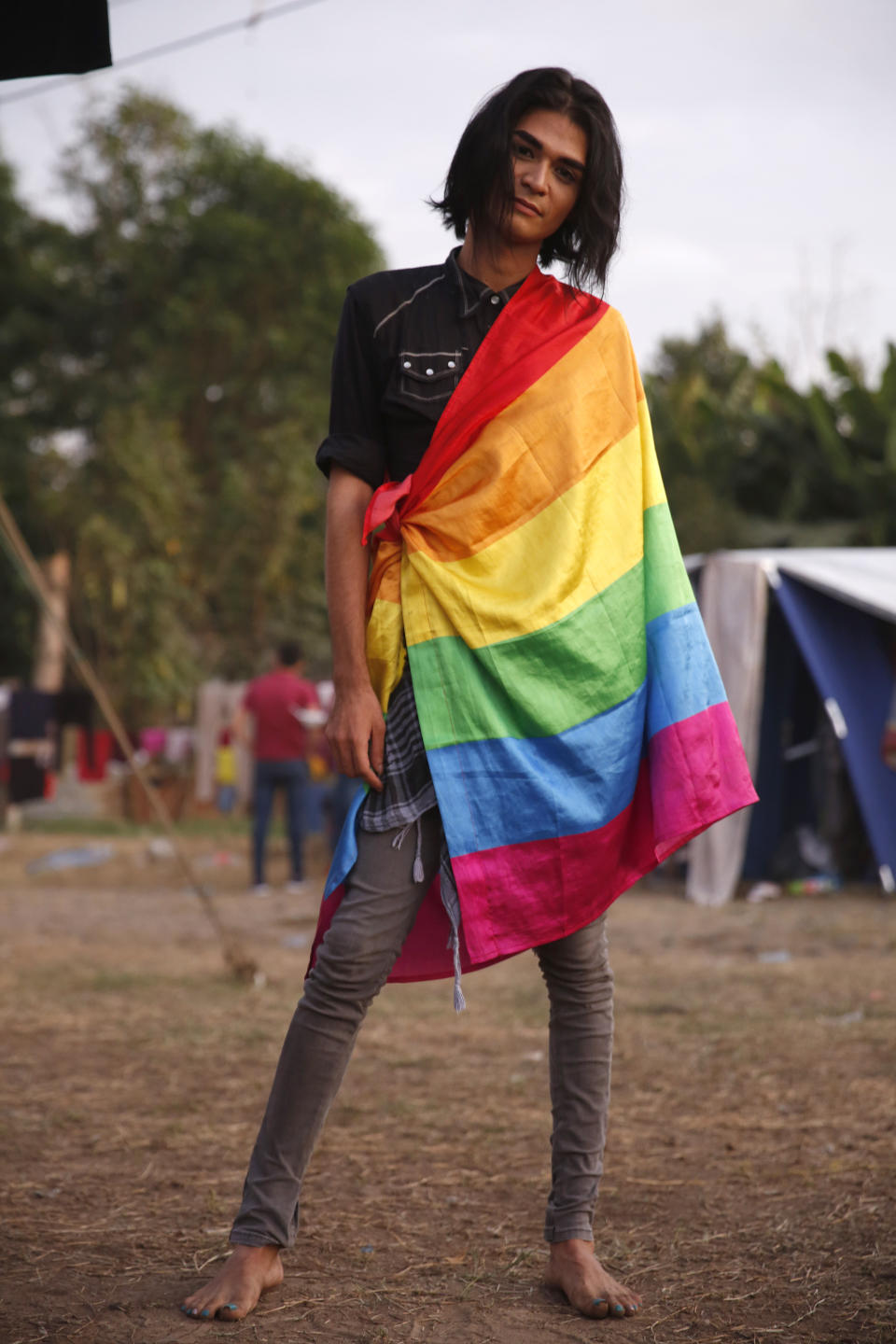 Honduran transgender migrant Esnny Argueta poses for a portrait at a temporary shelter set up by authorities for migrants arriving to Tecun Uman, Guatemala on the border with Mexico, Tuesday, Jan. 21, 2020. The 26-year-old said that violence against the LGBT community in Honduras and the difficulty of finding work are his main motivations for trying to reach the U.S. (AP Photo/Moises Castillo)