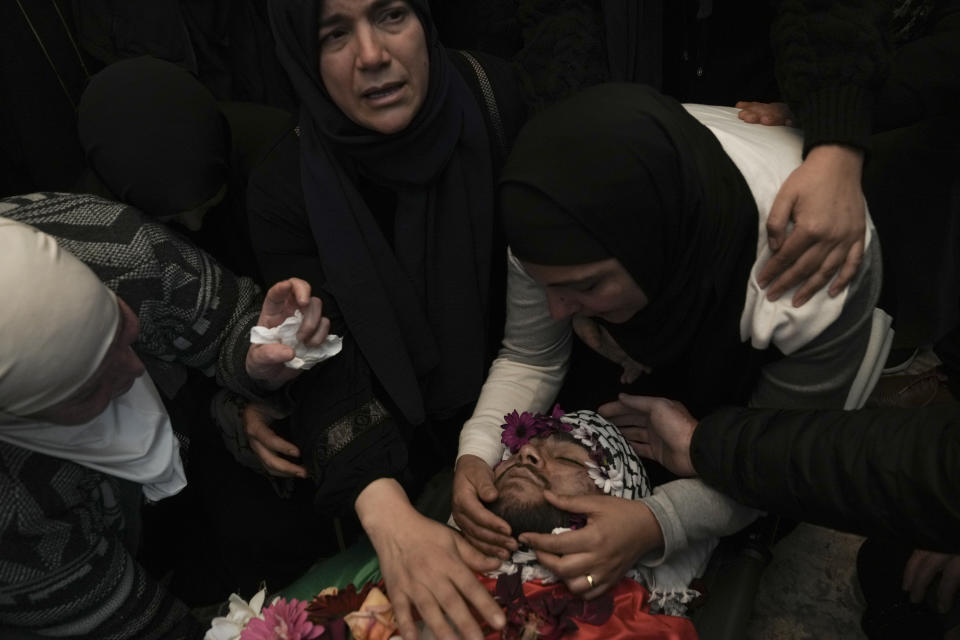 CORRECTS DETAILS OF DEATH Relatives mourn 17-year-old American Tawfiq Ajaq at his funeral in his family’s Palestinian home village in Al-Mazra'a ash-Sharqiya, West Bank, Saturday, Jan. 20, 2024. Ajaq was killed Friday by Israeli fire and police say they have launched an investigation. (AP Photo/Nasser Nasser)