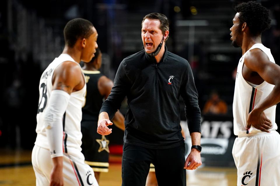 John Brannen instructs Cincinnati Bearcats players during a game against Vanderbilt on March 4 at Fifth Third Arena in Cincinnati.