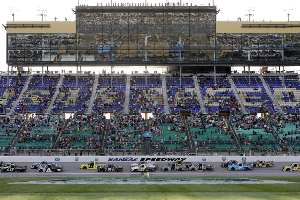 Drivers head down the front straightaway to start a NASCAR Truck Series auto race at Kansas Speedway in Kansas City, Kan., Saturday, May 14, 2022. (AP Photo/Colin E. Braley)