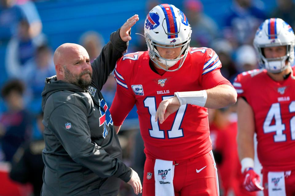 FILE - In this Oct. 20, 2019, file photo, Buffalo Bills offensive coordinator Brian Daboll, left, encourages quarterback Josh Allen as he warms up before an NFL football game Miami Dolphins, Sunday, Oct. 20, 2019, in Orchard Park, N.Y. Allen and Daboll are overseeing an offensive renaissance in Buffalo in which the suddenly pass-happy Bills are among the NFL's most explosive teams three weeks into the season. (AP Photo/Adrian Kraus, File)