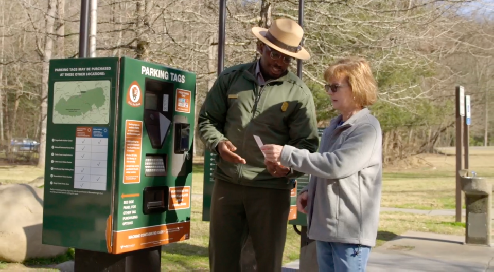Ranger Dexter Armstrong helps a visitor with her parking tag.