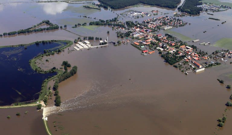 An aerial view shows houses flooded by the river Elbe after a dyke broke in Fischbeck, eastern Germany, on June 11, 2013. Deadly floods forging a path of devastation through central Europe for more than a week bore down on northern Germany Tuesday as troops raced to bolster sodden dykes