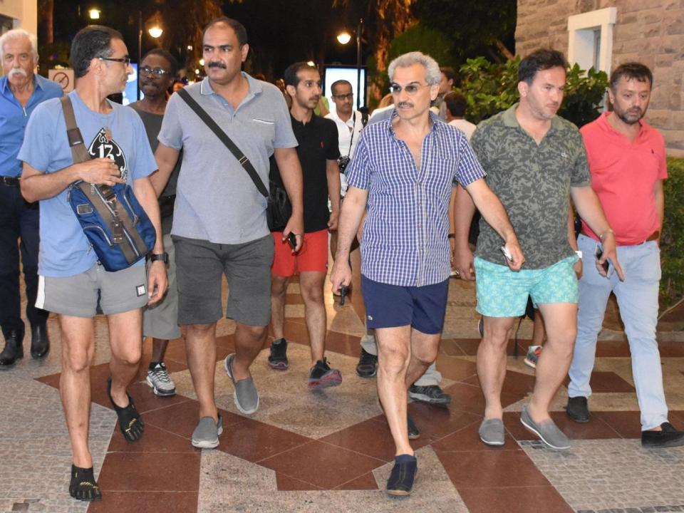 Saudi Prince Al-Waleed Bin Talal bin Abdulaziz al Saud (third on the right) arrives at a restaurant at Marina district with the advisor to the Turkish Prime Ministry, Taha Genc (second on the right) In Bodrum, Turkey (Ali Balli/Anadolu Agency/Getty Images)