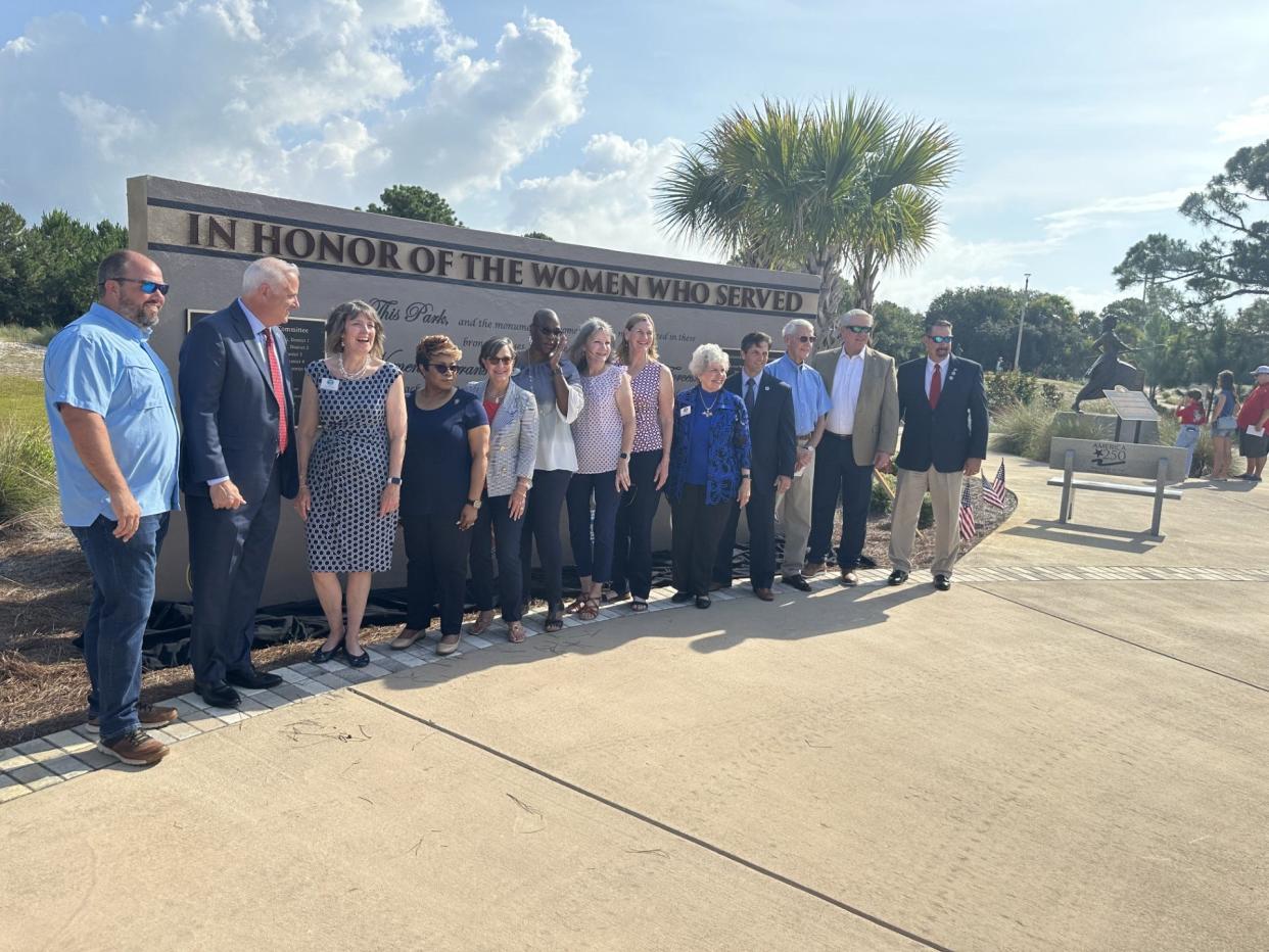 Okaloosa County Commissioners standing in front of the new memorial wall at the Women's Veterans Park.