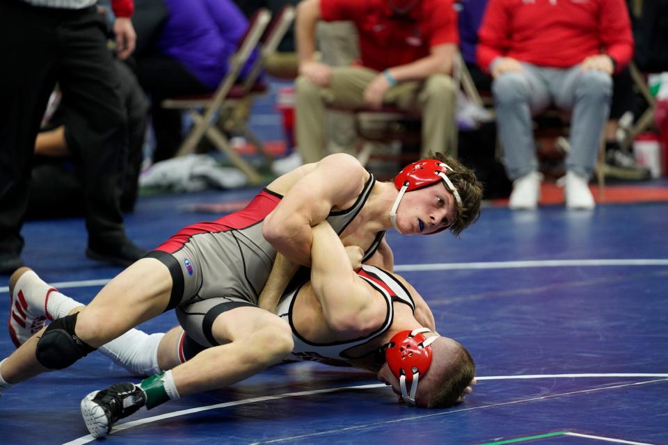 Fort Madison's Gavin Wiseman (top) looks for a half-Nelson in his Class 3A 138-pound match against Dylan Whitt of Cedar Falls  Thursday at Wells Fargo Arena in Des Moines.