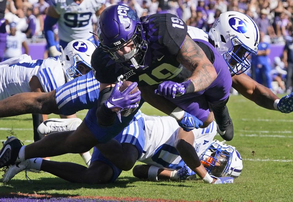 TCU tight end Jared Wiley (19) scores a touchdown against BYU defenders Jakob Robinson (0); Preston Rex, left; and AJ Vongphachanh during the first half of an NCAA college football game Saturday, Oct. 14, 2023, in Fort Worth, Texas. | LM Otero, Associated Press