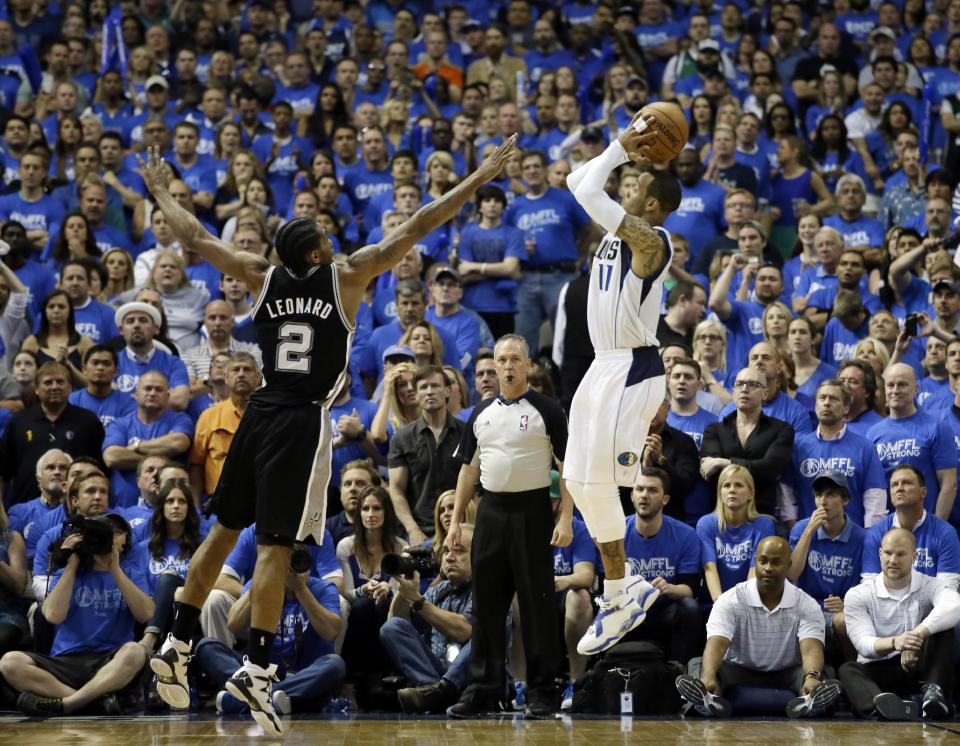 Dallas Mavericks' Monta Ellis, right, goes up to shoot as San Antonio Spurs' Kawhi Leonard (2) defends in the second half of Game 6 of an NBA basketball first-round playoff series on Friday, May 2, 2014, in Dallas. The Mavericks won 113-111. (AP Photo/Tony Gutierrez)