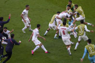 Iran's Rouzbeh Cheshmi celebrates with teammates after scoring his side's opening goal during the World Cup group B soccer match between Wales and Iran, at the Ahmad Bin Ali Stadium in Al Rayyan , Qatar, Friday, Nov. 25, 2022. (AP Photo/Manu Fernandez)