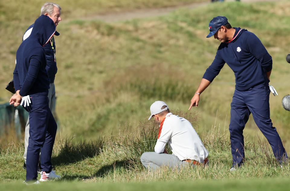 KOHLER, WISCONSIN - SEPTEMBER 25: Daniel Berger of team United States, Brooks Koepka of team United States, and Sergio Garcia of Spain and team Europe inspect the lie of a ball on the 15th hole during Saturday Morning Foursome Matches of the 43rd Ryder Cup at Whistling Straits on September 25, 2021 in Kohler, Wisconsin. (Photo by Warren Little/Getty Images)