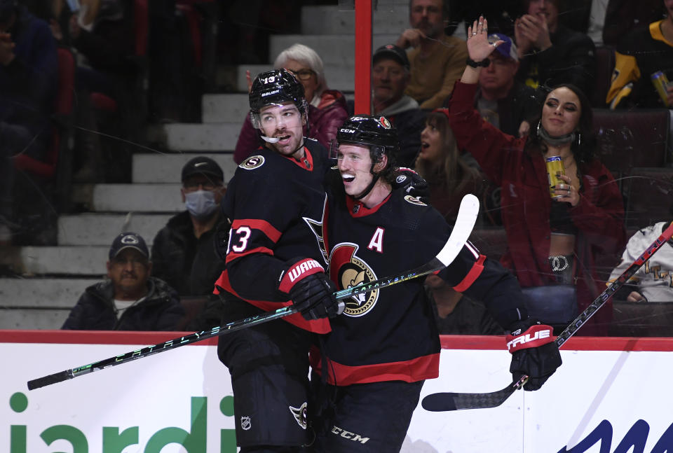 Ottawa Senators' Zach Sanford (13) celebrates with Thomas Chabot (72) after scoring against the Pittsburgh Penguins during the second period of an NHL hockey game in Ottawa, on Saturday, Nov. 13, 2021. (Justin Tang/The Canadian Press via AP)