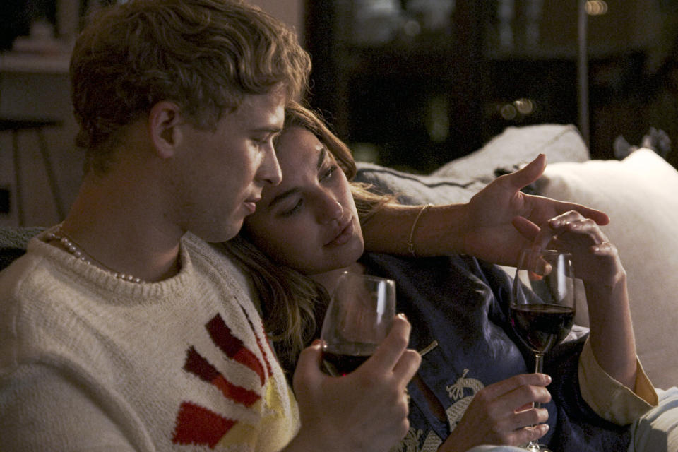 This image released by Freeform shows Tommy Dorfman, left, and Rainey Qualley in a scene from "Love in the Time of Corona," a two-part series airing Aug.22-23 on Freeform. (Freeform via AP)