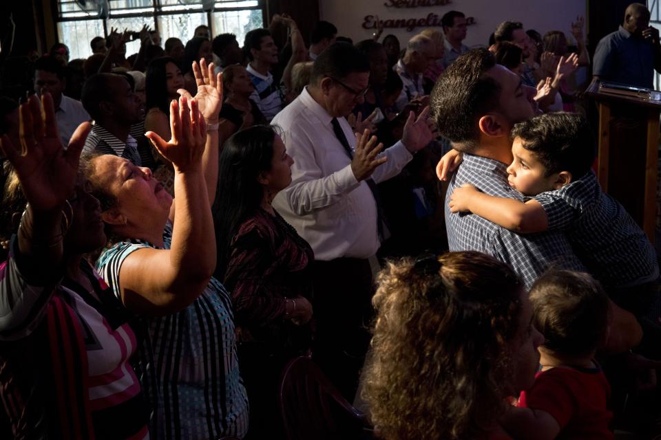 FILE - Evangelicals pray during a memorial service in Havana, Cuba, May 20, 2018. The 1959 revolution led by Fidel Castro installed an atheist, Communist government, but 65 years later practitioners of diverse religions gather to pray, sing and worship across the Communist-run island. (AP Photo/Ramon Espinosa, File)