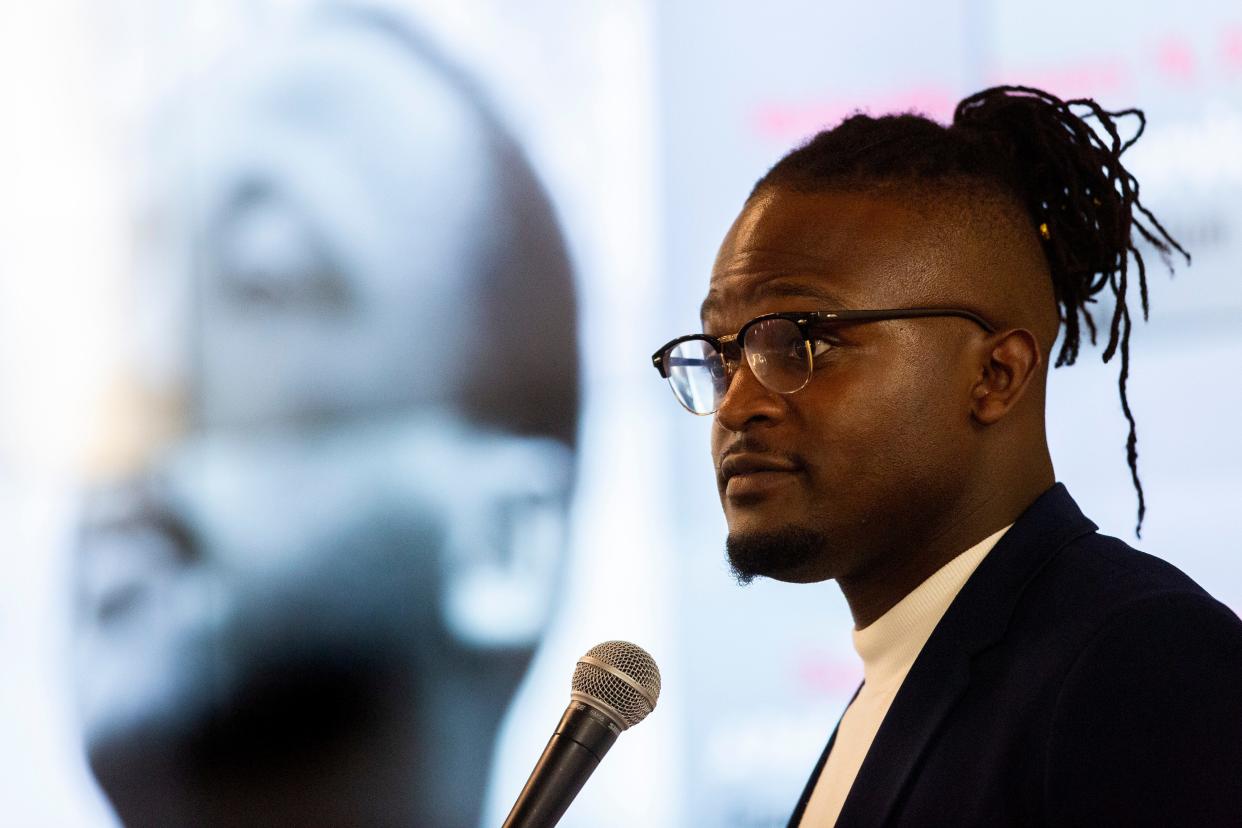 Wisdom Cole, the national director of the NAACP Youth and College Division, gives his keynote speech during the Martin Luther King Jr. Celebration Brunch at Lane College as an image of MLK is projected on a screen behind him on Monday, January 16, 2023, in Jackson, Tenn.