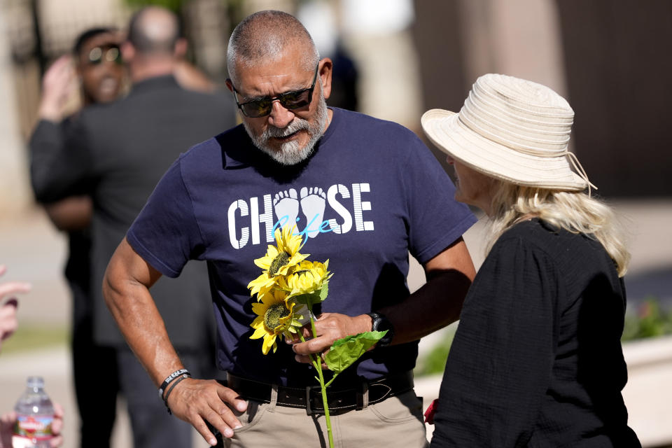 A anti-abortion supporter stands outside the House chamber, Wednesday, April 17, 2024, at the Capitol in Phoenix. (AP Photo/Matt York)