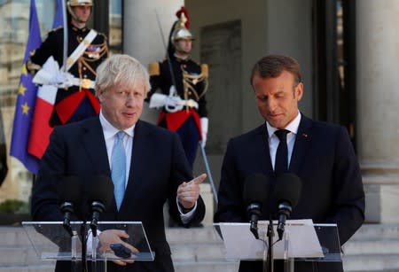 French President Emmanuel Macron and British Prime Minister Boris Johnson deliver a joint statement before a meeting on Brexit at the Elysee Palace in Paris