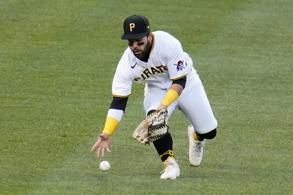 Pittsburgh Pirates left fielder Ka'ai Tom fields an RBI double hit by St. Louis Cardinals' Nolan Arenado during the third inning of a baseball game in Pittsburgh, Friday, April 30, 2021. (AP Photo/Gene J. Puskar)