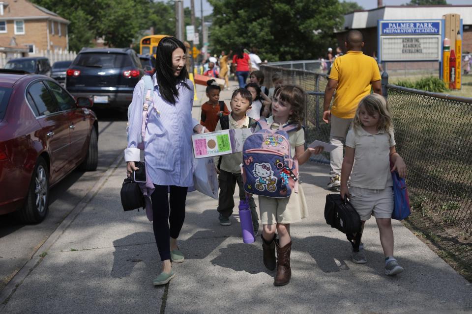 Joori Jung, 40, of Troy, walks students from Palmer Park Preparatory Academy to the after-school program at Artlab J, a few blocks away, in Detroit on June 7, 2023. Jung sees education and community as big parts of Artlab J's programming after she had her two children, Lyle, 7, and Sia Lee, 4, who also go to Palmer Park Prep.